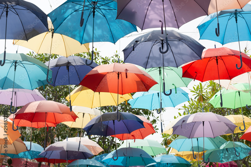 Colorful umbrellas floating in the sky