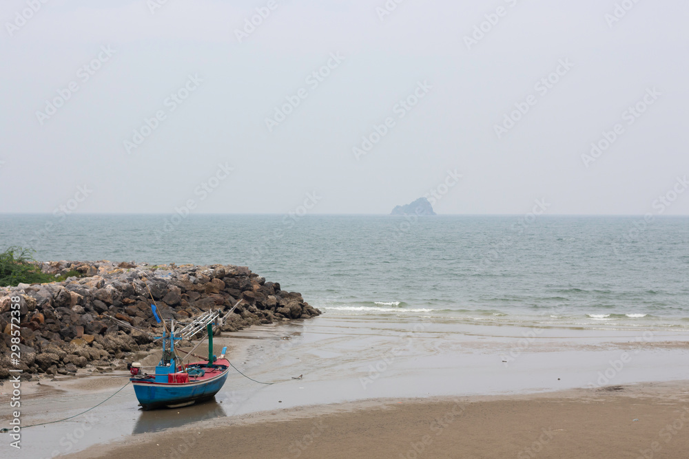 Fishing boats are parked on the beach by the sea Fishing boats are parked on the beach by the sea