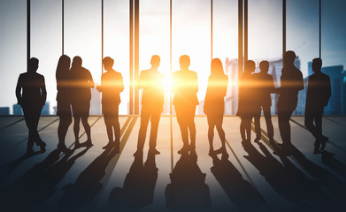 Double exposure image of many business people conference group meeting on city office building in background showing partnership success of business deal. Concept of teamwork, trust and agreement.