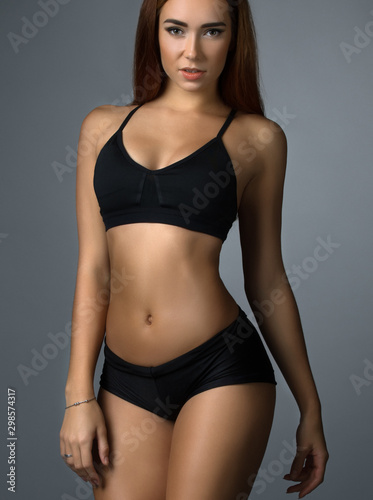 Pretty fitness trainer in black top and short © Wisky