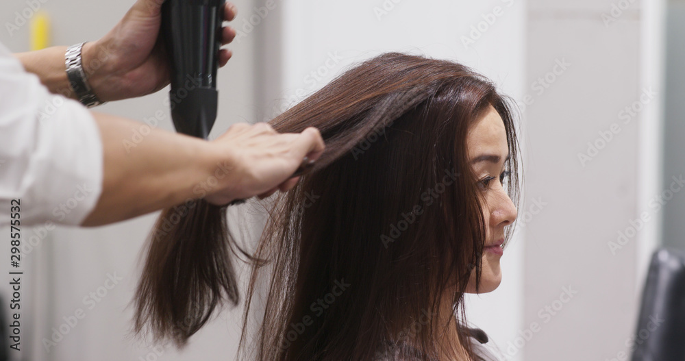 Fototapeta premium Woman drying hair in the salon