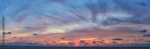 Phuket beach sunset, colorful cloudy twilight sky reflecting on the sand gazing at the Indian Ocean, Thailand, Asia. © Jeremy