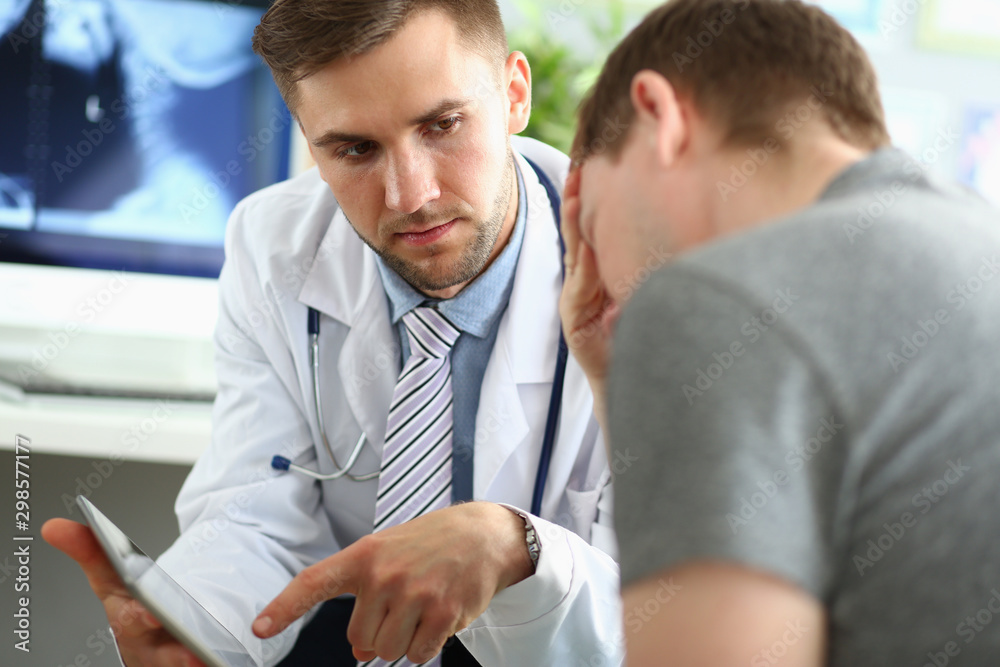 Doc explaining diagnosis to man Doc explaining diagnosis to man