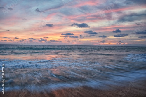 Phuket beach sunset, colorful cloudy twilight sky reflecting on the sand gazing at the Indian Ocean, Thailand, Asia. © Jeremy