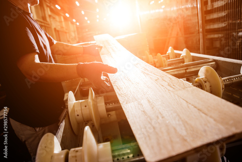 Fotografie Carpenter with fibreboards at furniture factory workshop
