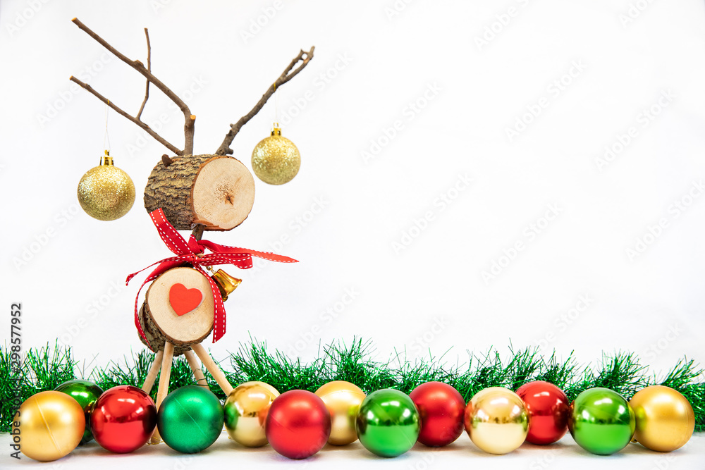 Fototapeta premium Wooden reindeer Christmas toy on isolated white background with tinsel and decorations 