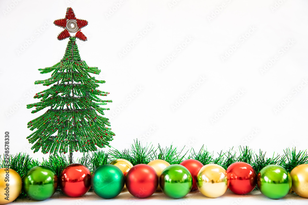 Wire Christmas tree with Christmas decorations and tinsel on a white background  