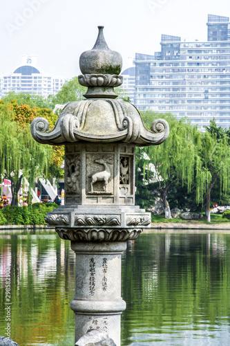 Pagoda statue in park with pond
