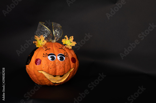 a painted pumpkin on a black background, the concept of Halloween