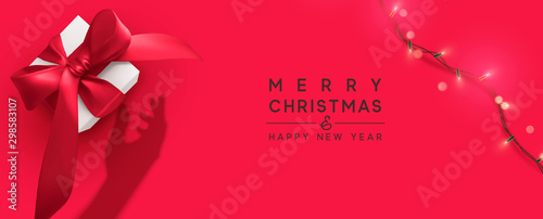 Merry Christmas and Happy New Year. Background with realistic gift box, bright christmas lights garland. Silhouette shadow from the hands holds Xmas presents. Creative getting card, holiday banner.