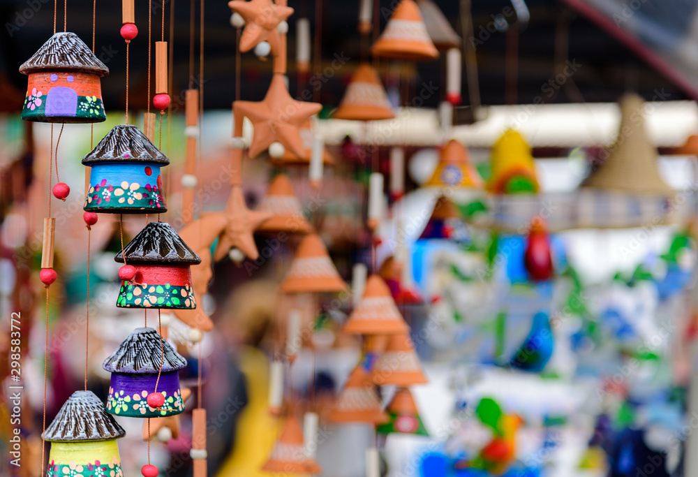 Obraz premium Children's colourful small house toys hanging on strings at a market stall at Queen Victoria Market, Melbourne, Australia