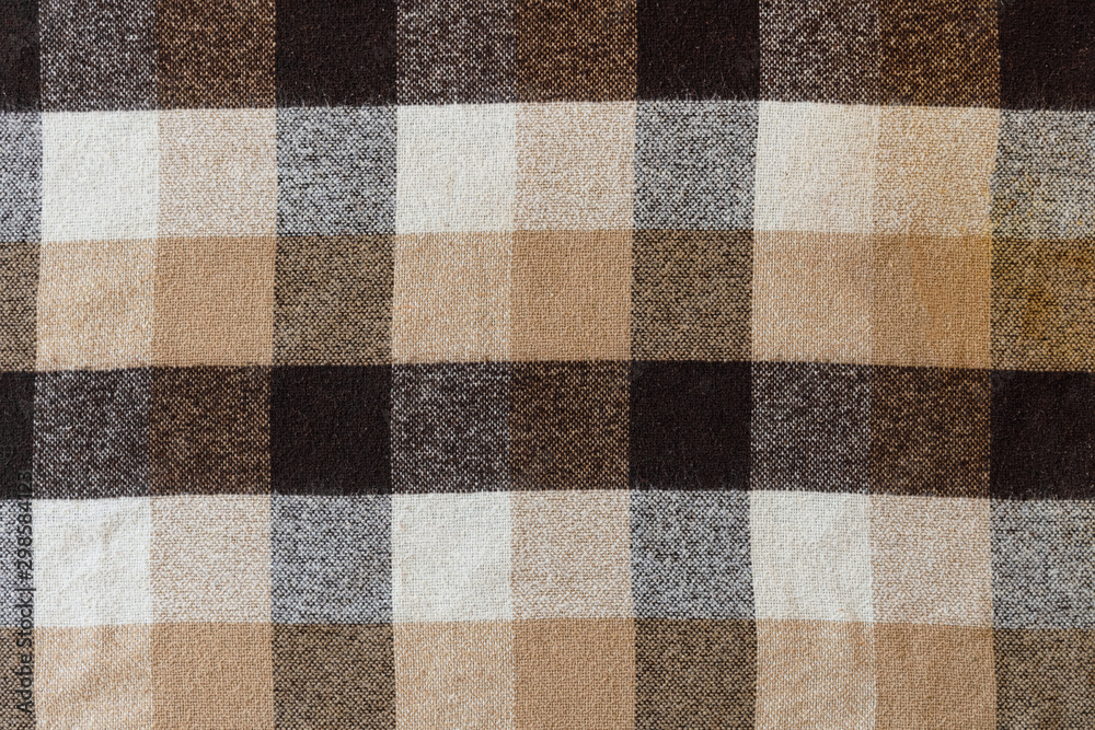 Brown checkered wool plaid fabric texture. tartan texture Brown checkered wool plaid fabric texture. tartan texture