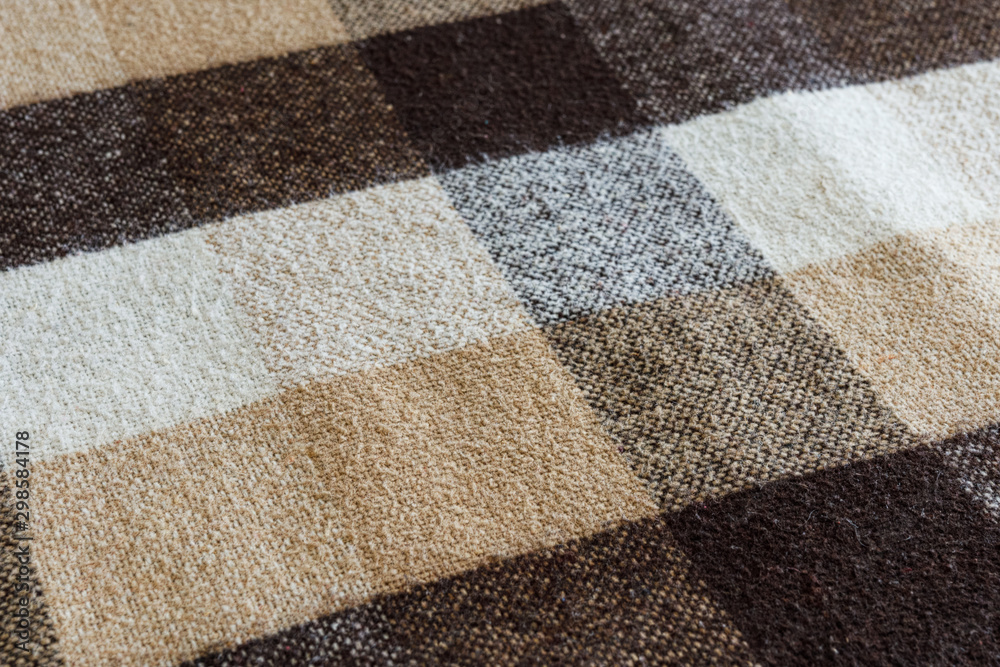 Fototapeta premium Brown checkered wool plaid fabric texture. tartan texture