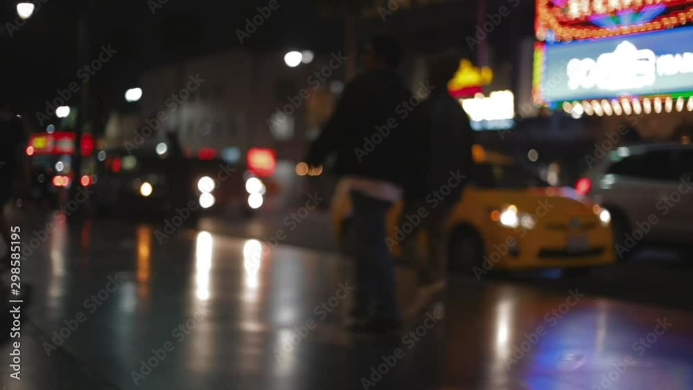 out of focus people walking by on Hollywood Boulevard Walk of Fame at night. out of focus people walking by on Hollywood Boulevard Walk of Fame at night.