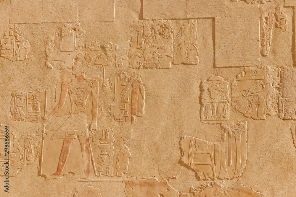 Ancient egyptian paintings and hieroglyphs on a wall in Mortuary temple of Hatshepsut in Luxor, Egypt