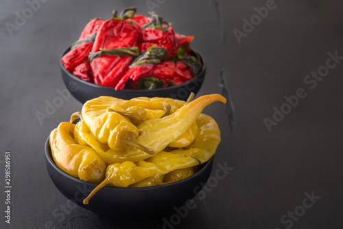 Fermented products red and green hot peppers on a black table - traditional Korean food. Copy space