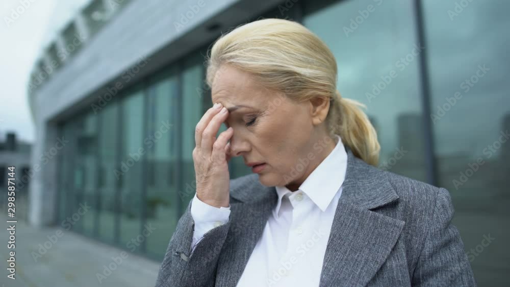 Anxious company head feeling unwell, touching head and closing eyes, migraine Anxious company head feeling unwell, touching head and closing eyes, migraine