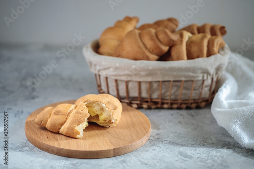 Fresh croissants are in the breadbox on the table. Bakery. Close-up, minimalism. Tasty breakfast. photo