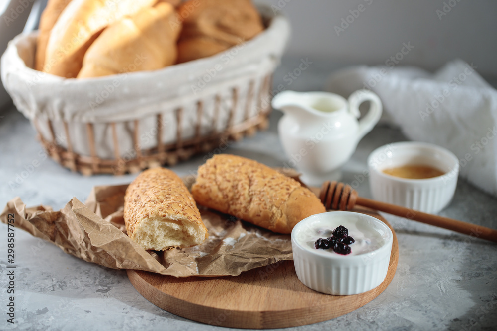 Tasty breakfast with French baguette and croissants with honey. Fresh bakery. Still life