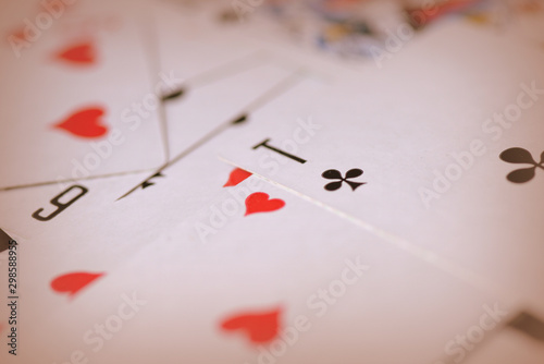 Playing cards on a dark background close up. Retro style toned