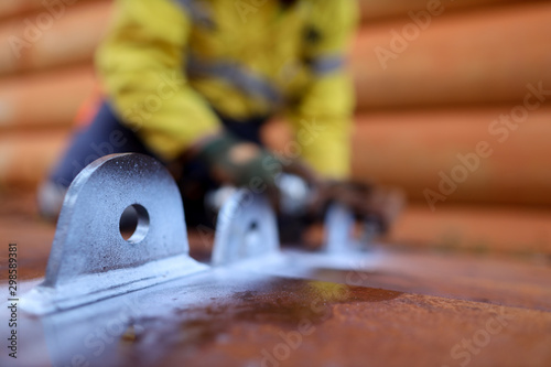 Billede på lærred Crane lifting lugs with white paint with defocused NDT technician conducting MPI