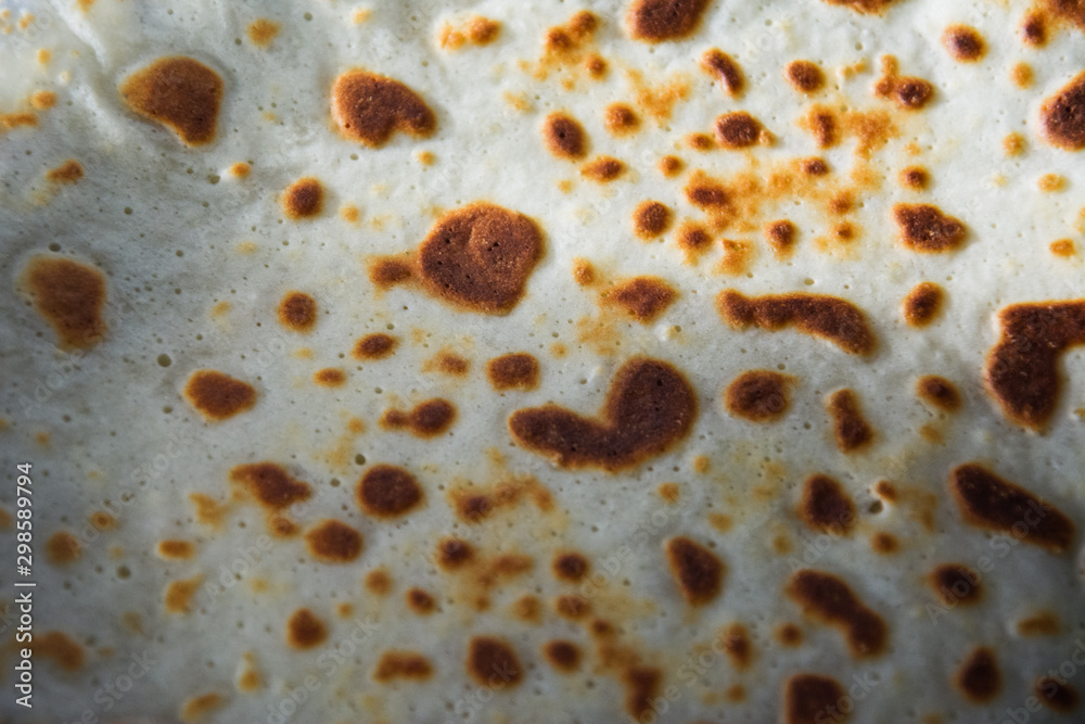 Pancakes are flat and round flour products prepared from liquid dough by frying in a frying pan. Consist of Flour, water or milk, eggs, butter. Dish of Russian national kitchen. Sun symbol. Pancakes are flat and round flour products prepared from liquid dough by frying in a frying pan. Consist of Flour, water or milk, eggs, butter. Dish of Russian national kitchen. Sun symbol.