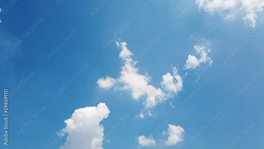 White puffy clouds and blue sky time-lapse with long second duration for background and graphics in daylight. White puffy clouds and blue sky time-lapse with long second duration for background and graphics in daylight.