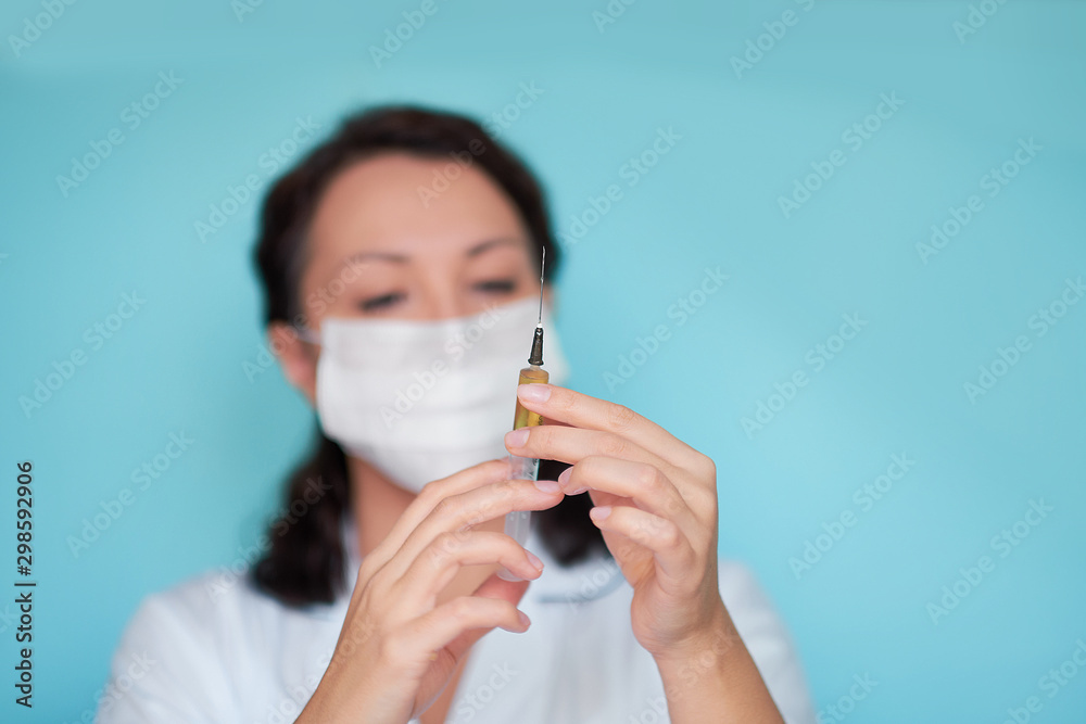 doctor or scientist in laboratory holding a syringe with liquid vaccines for children or older adults, or cure animal diseases. Concept:diseases,medical care,science, anesthesia,euthanasia,diabetes. doctor or scientist in laboratory holding a syringe with liquid vaccines for children or older adults, or cure animal diseases. Concept:diseases,medical care,science, anesthesia,euthanasia,diabetes.