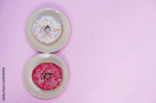 Beautiful juicy donut with a sweet cream..Cupcake on a pink background for kitchen design.
