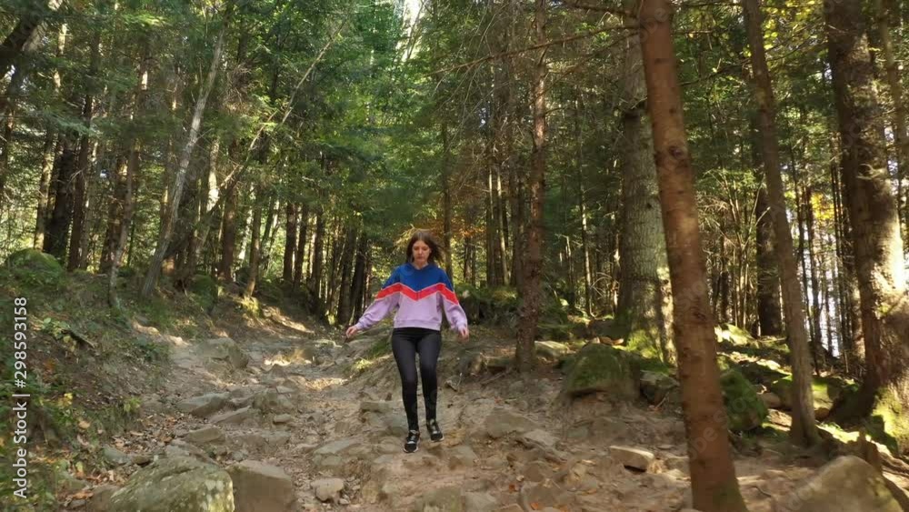 Young girl running trough the wild forest. Carpathian Mountains. Young girl running trough the wild forest. Carpathian Mountains.