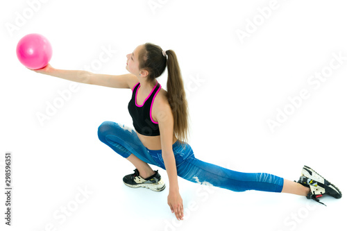 Girl gymnast performs exercises with the ball.