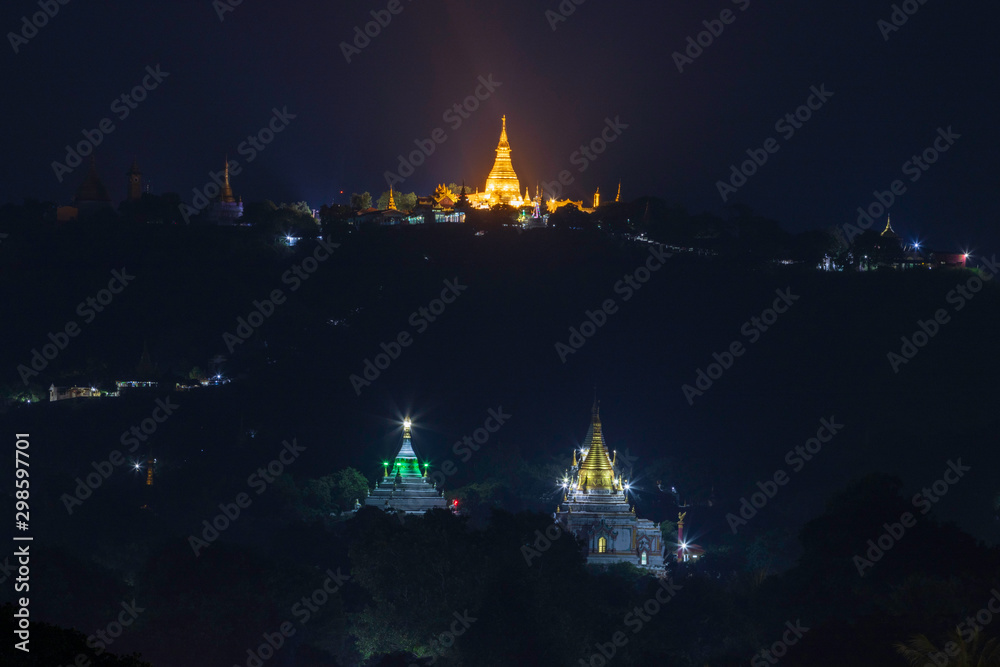Three pagodas lit up beautifully at night at Sagaing city, Myanmar.