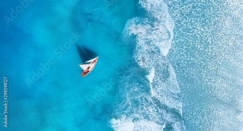 Wave and boat on the beach as a background. .Beach and waves from top view. Turquoise water background from top view. Top view from drone. Travel - image © biletskiyevgeniy.com