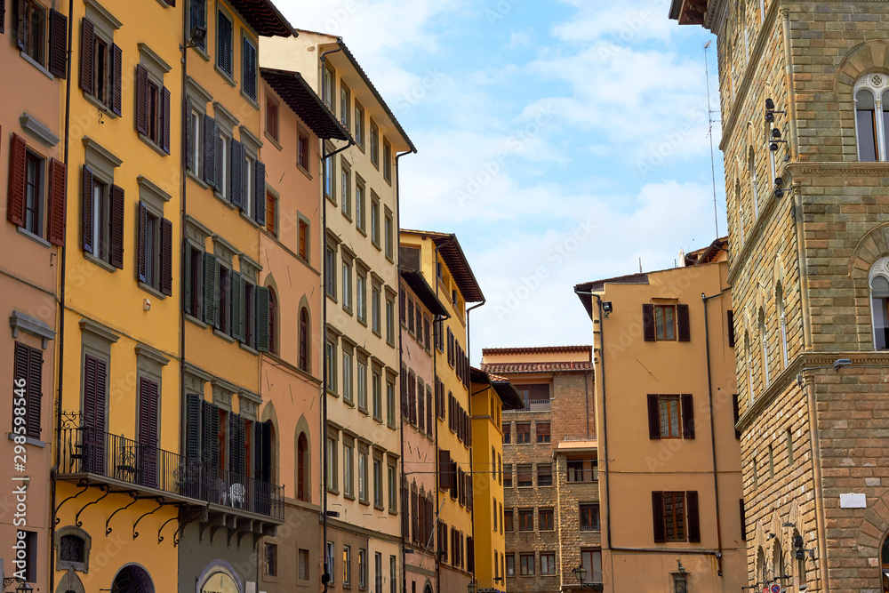 Street with old traditional Italian houses with wooden windows and balconies in Florence, Italy