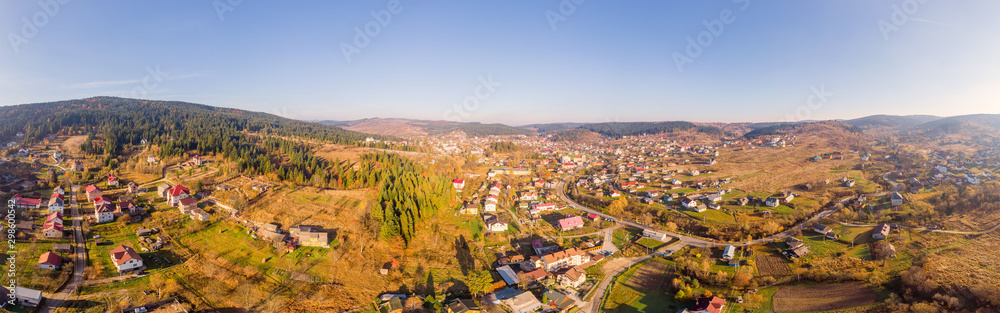 Fototapeta premium Beautiful 180 degrees scenic landscape of popular healing spa resort in Carpathians, Skhidnytsia urban-type settlement, Ukraine. Balneological resort with mineral springs. Autumn. Aerial drone view