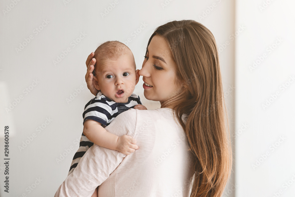 Portrait of young mother with adorable yawning baby Portrait of young mother with adorable yawning baby