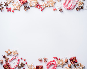 Christmas composition, New Year greeting card. Mockup with festive food decorations and gingerbread cookies on white background. Copy space