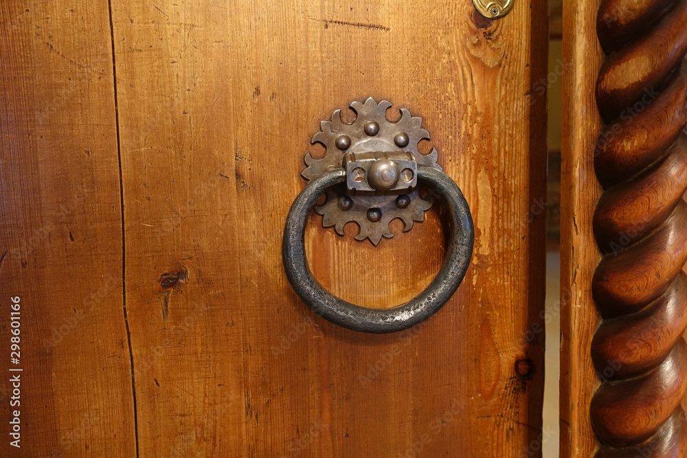 Antique doorknob in the form of a ring on an old door Antique doorknob in the form of a ring on an old door