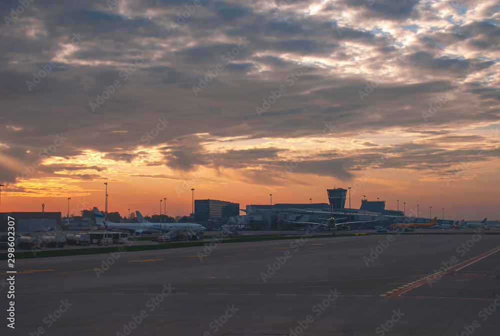 Fototapeta premium The sun rises over Warsaw Airport in Poland