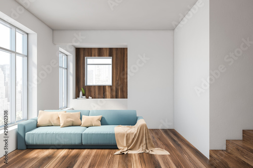 White living room interior with blue sofa