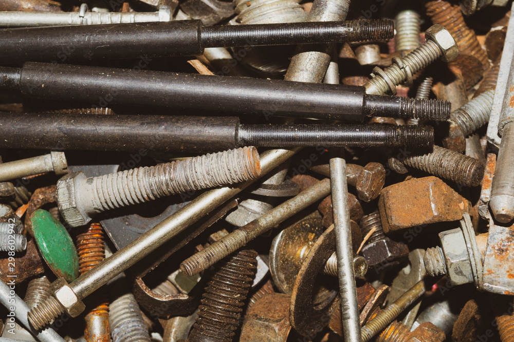 Pile of fasteners and screws close up. scrap metal. different metal parts Pile of fasteners and screws close up. scrap metal. different metal parts