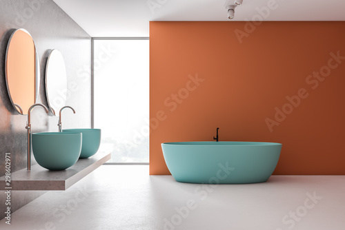 Orange and gray bathroom with blue tub