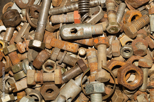 Bolts and nuts of different sizes. scrap metal. industrial background