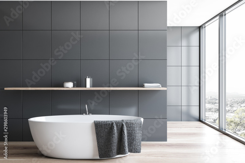 Panoramic gray tile bathroom interior with tub