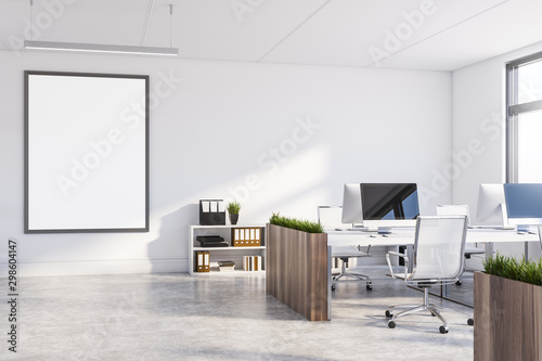 White office with dark wooden tables and poster photo