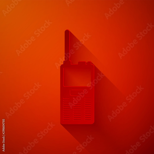 Paper cut Walkie talkie icon isolated on red background. Portable radio transmitter icon. Radio transceiver sign. Paper art style. Vector Illustration