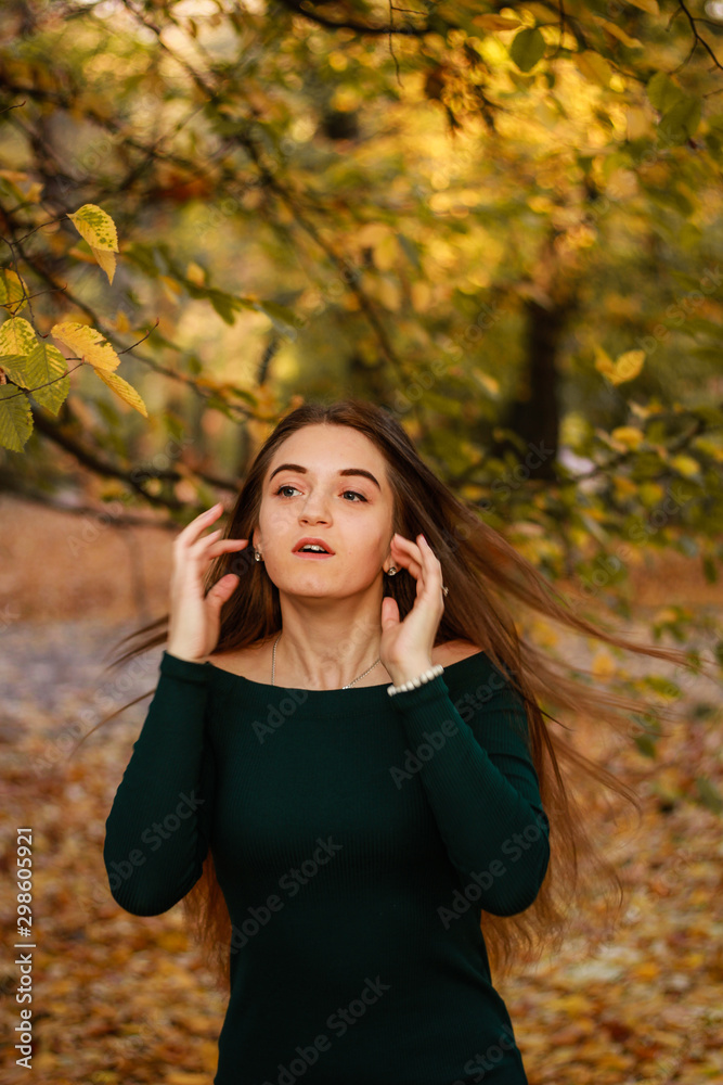Autumn girl portraits. Emerald dress. Yellow leaves and trees. Park. Warm atmosphere. Autumn girl portraits. Emerald dress. Yellow leaves and trees. Park. Warm atmosphere.