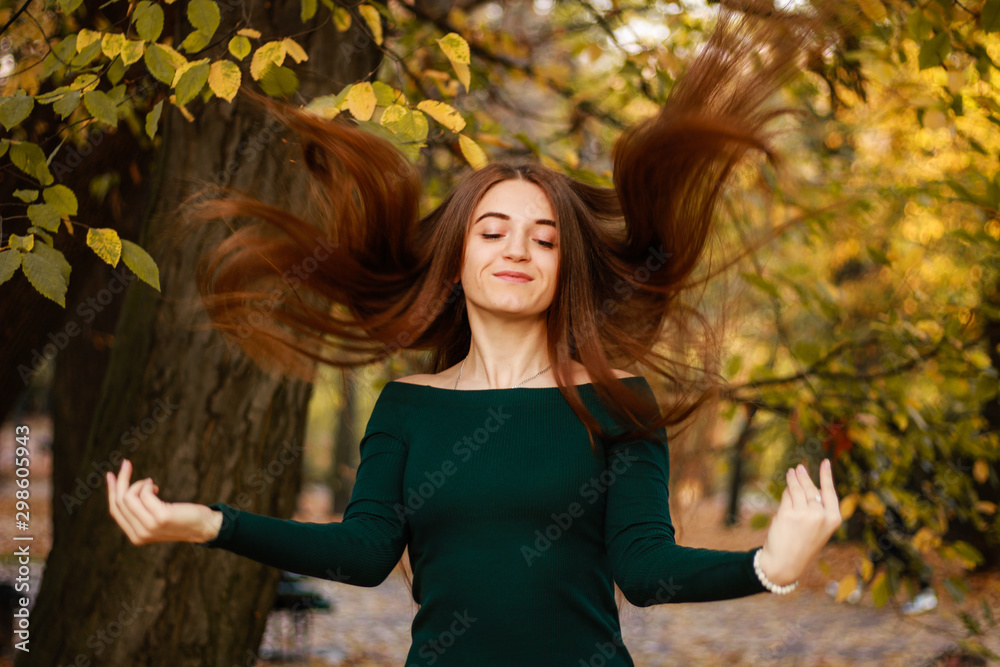 Autumn girl portraits. Emerald dress. Yellow leaves and trees. Park. Warm atmosphere. Autumn girl portraits. Emerald dress. Yellow leaves and trees. Park. Warm atmosphere.