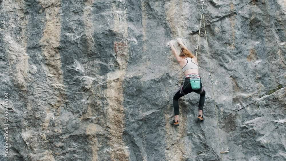 young woman climber climbs a rock young woman climber climbs a rock