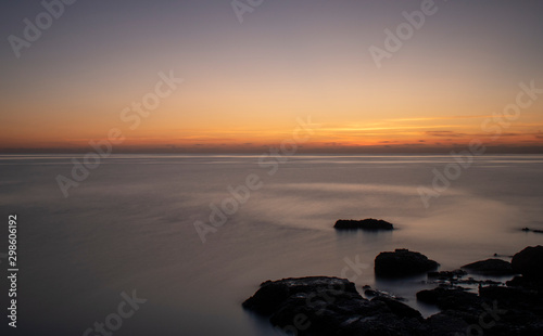 Pre Sunrise near Cala Bona Mallorca with a flat sea giving a surreal feel to the early morning.